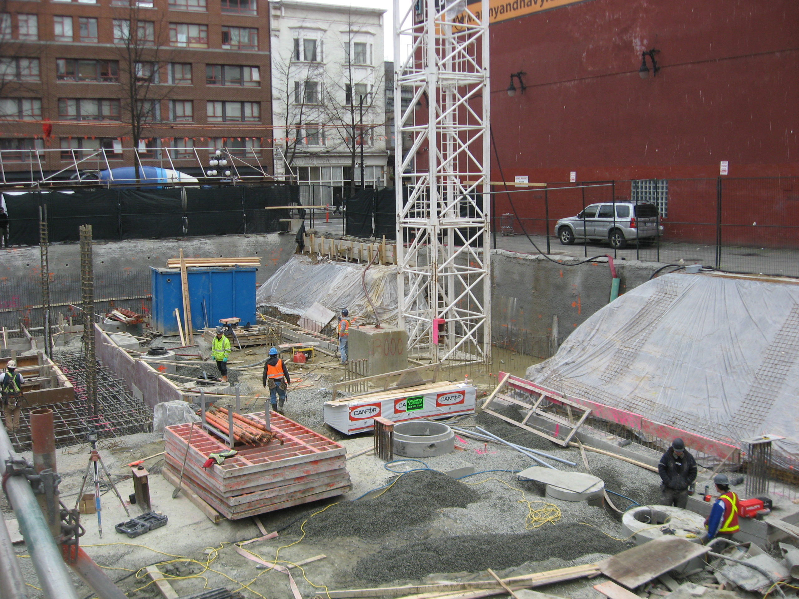 60 West Cordova Street's worksite is being set up by construction workers.